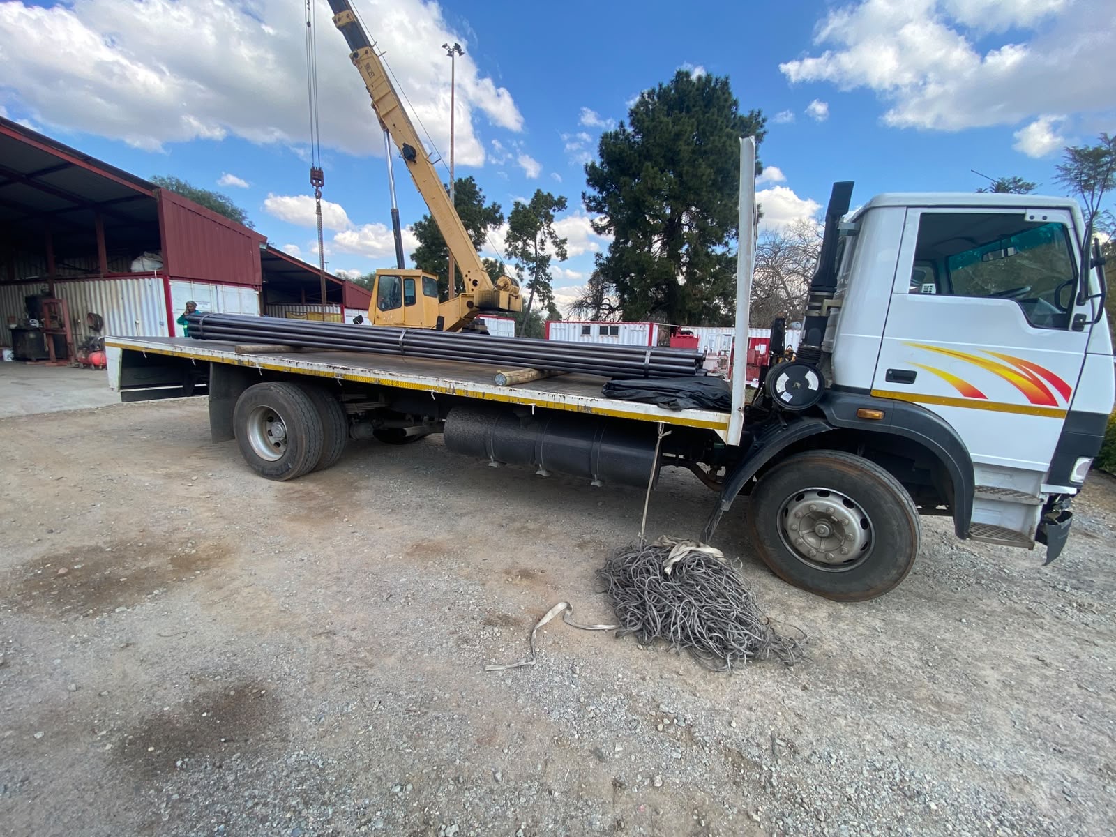 Skylands flat-deck truck collecting a bundled steel load